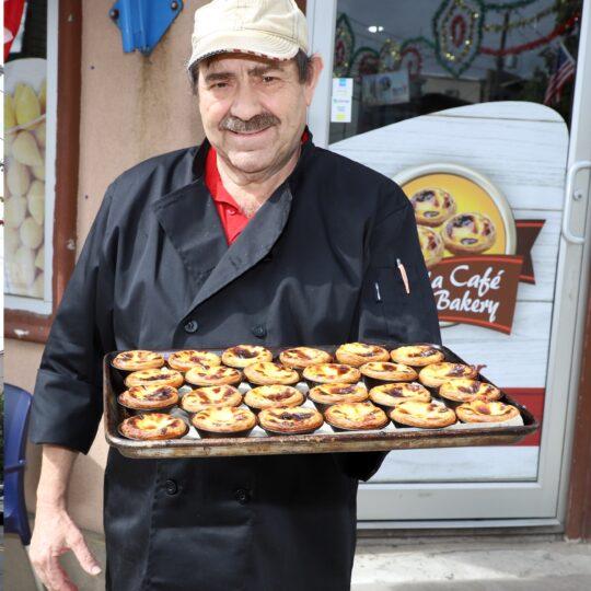 Antonio Silva, Canela Bakery & Coffee chef holding a tray full of famous pasteis de nata