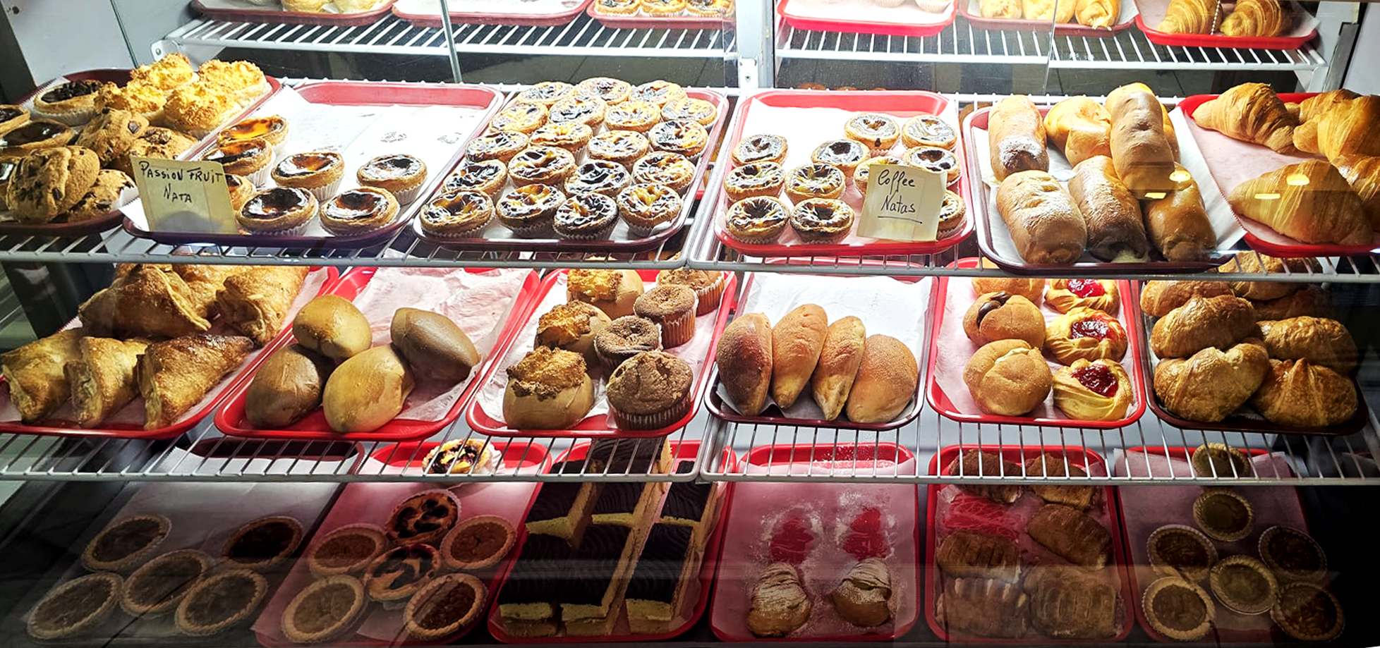 Canela bakery coffee store showcase full of breads, pies and pastel de nata