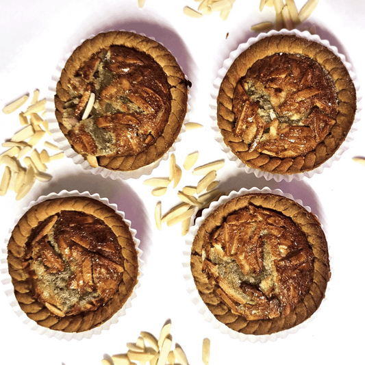 four small almond pies over a white table