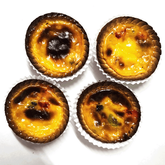 four small bombocado pies over a white table